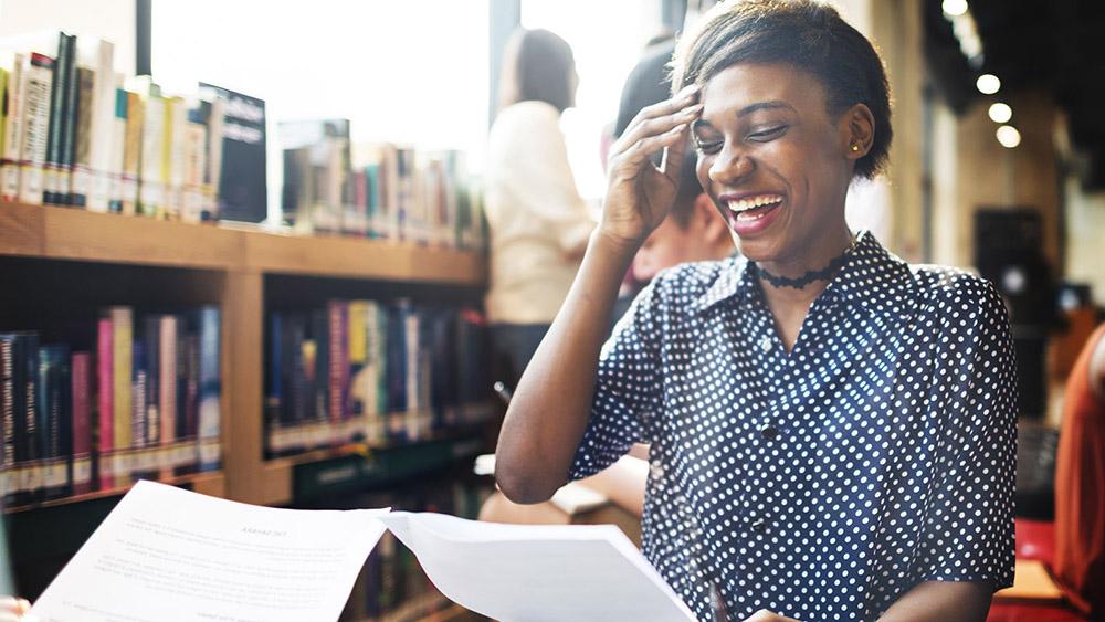 Young lady laughing in a library